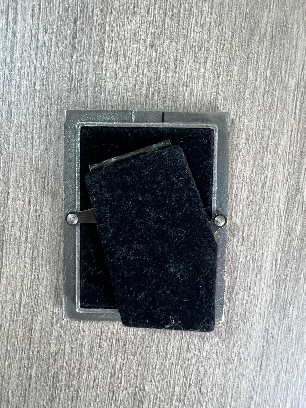 small ornate silver-finish picture frame displaying a real pressed 4 leaf clover